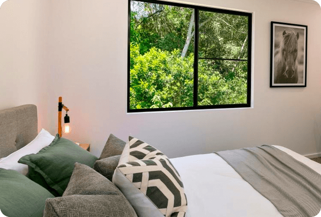 Bedroom of a residential portable home with glass windows
