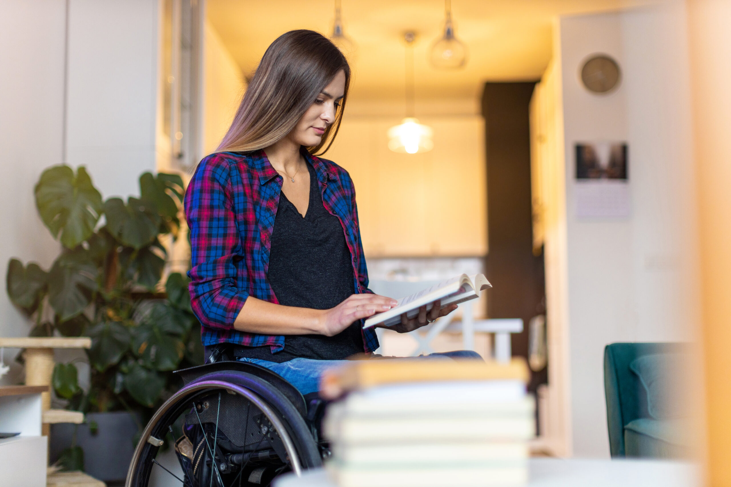 Woman in wheelchair Reading Book in Elite Portable Home